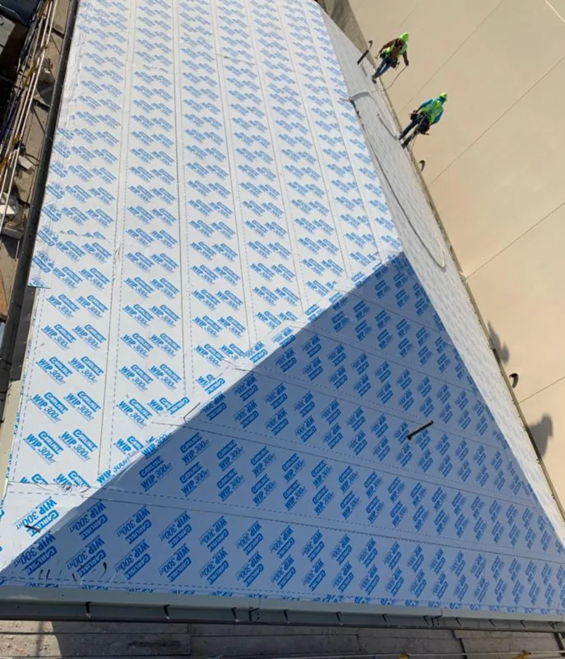 Professional roofers installing underlayment on a metal roof in Sayreville